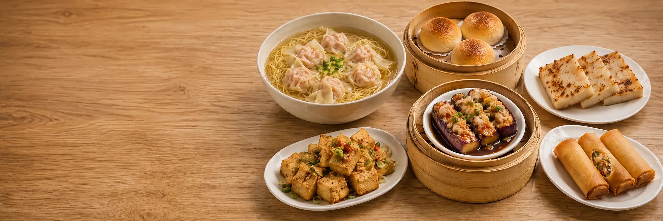 Dim sum baskets, tea, and small dishes on a restaurant table